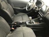 a picture of the interior of a car with a cup holder in the center