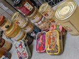 many different types of tins and containers on the table