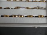 a lot of gold rings on display in a box