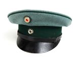 a green hat with a red button on it