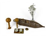 a boat shaped object with a clock and other items