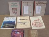 several books are sitting on a table in front of a wall
