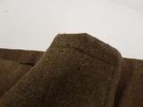 the back of a pair of brown pants sitting on top of a white table