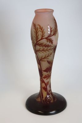a glass vase with a tree on it on a stand