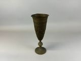 a small vase that is sitting on a white surface