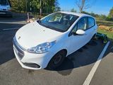 a small white car parked in a parking lot