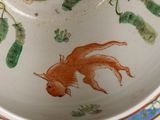 a bowl with a fish painted on it on a table