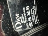 a close up of a bottle of dior perfume on a table