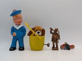 toy figurines of a man and a dog in a basket