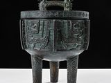 a large bronze bowl with a design on it