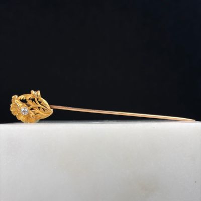 a close up of a gold stick with a flower on it
