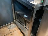 a stainless steel oven in the corner of a kitchen