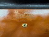 brown leather purse with gold hardware and name on it