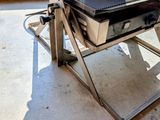 a grill that is sitting on a stand in a room
