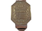 an old brass plate with the name of a city on it