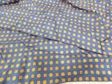 a close up of a blue tie with yellow dots