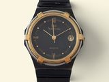 a black and gold watch on a white surface