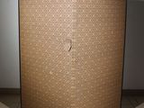 a brown screen with a pattern on it on a tiled floor