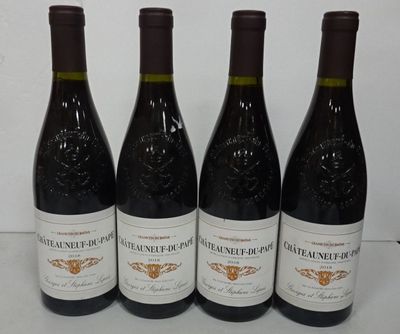 four bottles of wine are lined up on a table