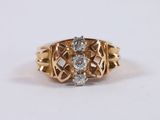 a close up of a gold ring with two diamonds on it