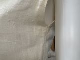 a white chair that has a white cloth on top of it
