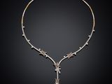 a diamond and gold necklace, by businessperson