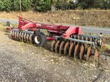 an image of a tractor with a plow on the side of the road