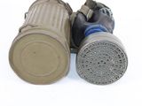 two gas masks that are sitting on a white surface