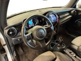 the interior of a small car with a steering wheel and dashboard controls