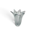a glass vase that is sitting on a white surface