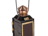 a small metal lantern with a wooden handle on a white background