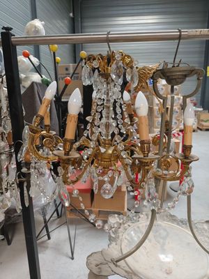 a chandelier that is sitting on a stand in a room