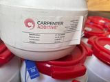a white container with a red lid sitting on top of a pile of white containers