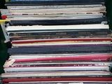 a lot of records in a green bin on the table
