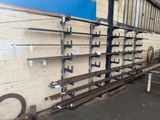 a wall of metal pipes in a warehouse with a blue wall