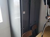 a table with two chairs and a refrigerator in the room