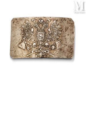 a close up of a metal belt buckle with a coat of arms on it