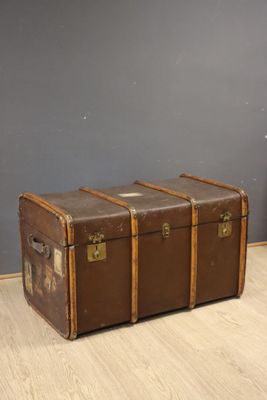 a brown trunk sitting on the floor in a room