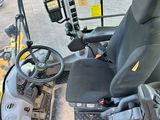 a picture of a forklift driver ' s seat and steering