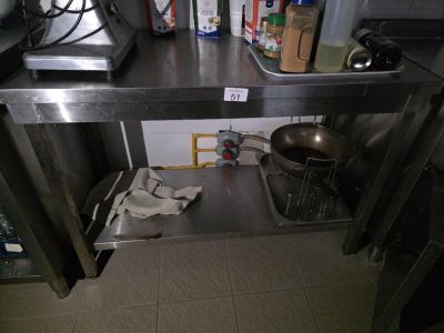 a stainless steel counter with a sink and a pot on top of it