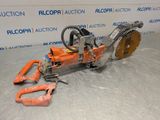 a close up of a chainsaw on a table with a piece of equipment