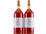 two bottles of wine sitting next to each other on a white surface