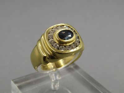 an image of a gold ring with a sapphire stone in the center