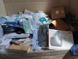 a cardboard box full of electronics and other items in it