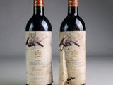 two bottles of wine sitting next to each other on a table