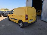 the yellow van is parked in the parking lot next to other cars