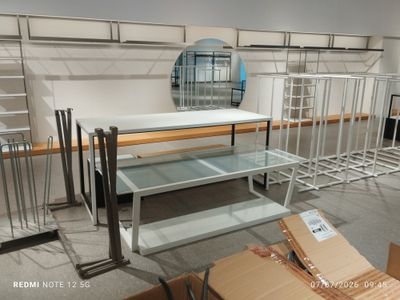 a room with shelves and a mirror in it