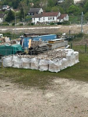 un camion garé à côté d'une pile de bois