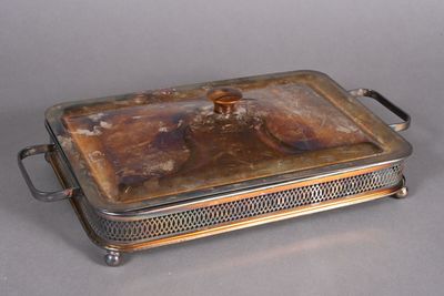 a silver plate with a lid that has food inside of it