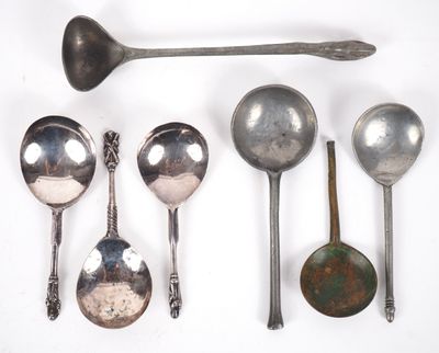 several spoons and spoon spoons are lined up on a white surface